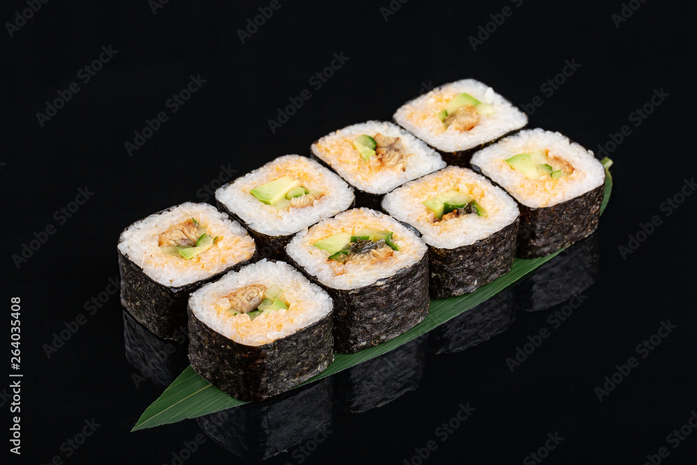 sushi with eel, avocado and cucumber on banana leaf sushi with eel, avocado and cucumber on banana leaf