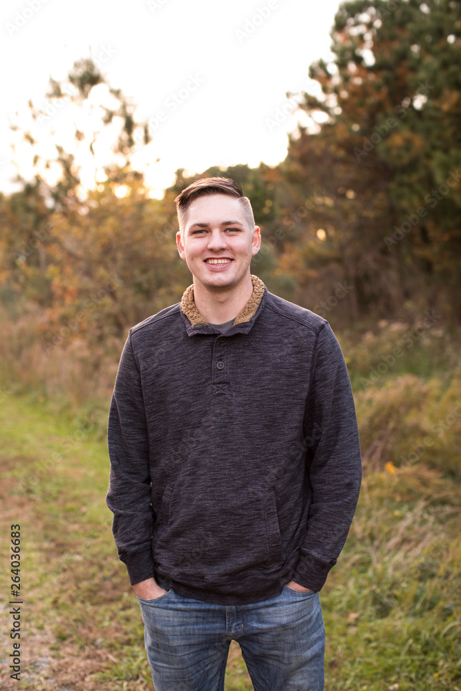 Smiling, Confident Young Man on Path at Sunset Smiling, Confident Young Man on Path at Sunset