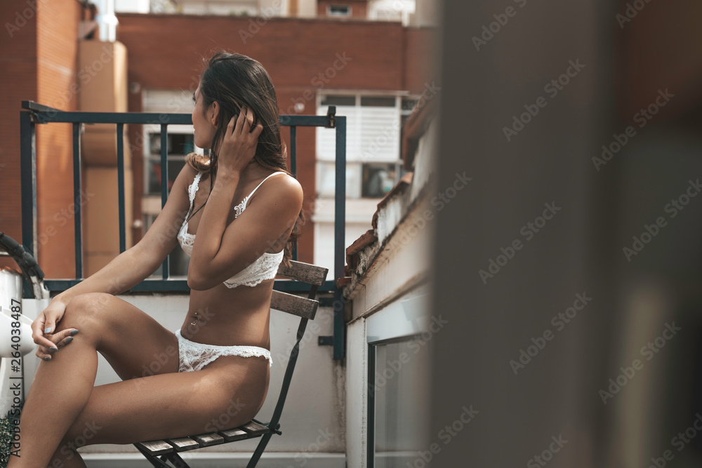 sexy and gorgeous Asian filipino girl sitting on a chair outside on a  balcony in a white lacy lingerie set Stock Photo | Adobe Stock