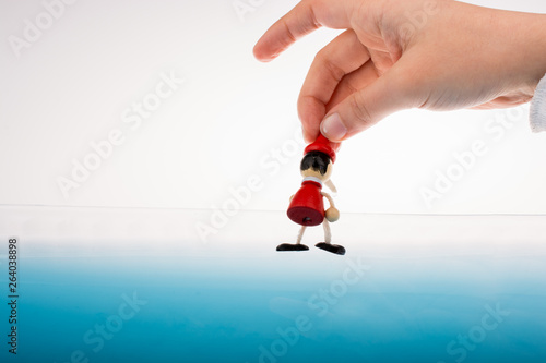 Hand holding Pinocchio on i...