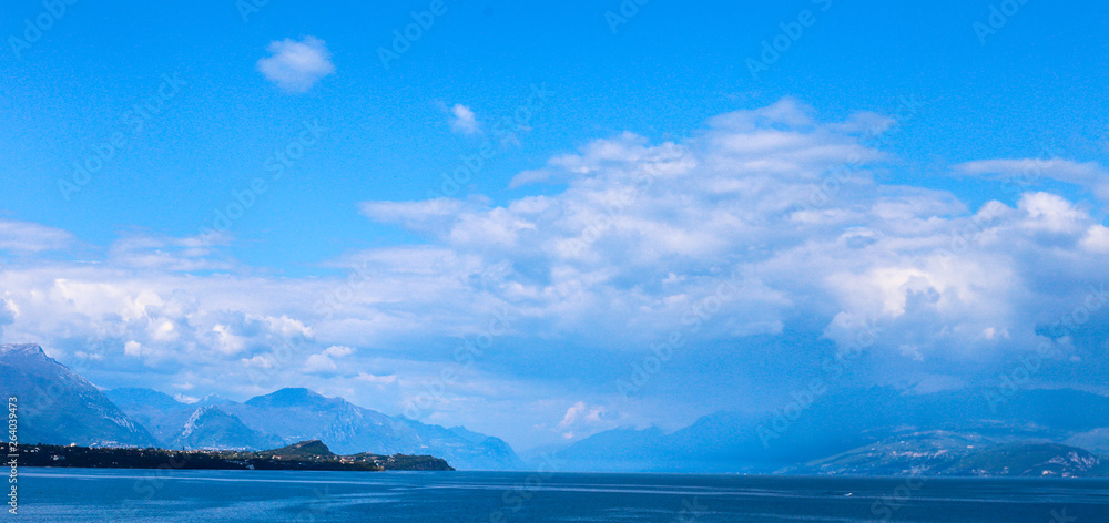 lake in the mountains with blue clouds and high rocks 