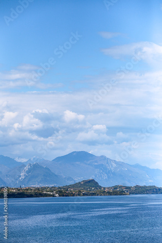 lake in the mountains with blue clouds and high rocks 