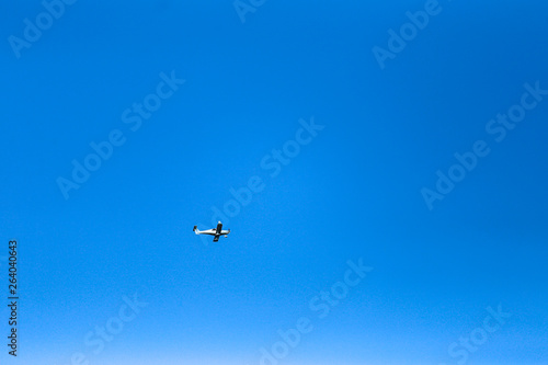 small plane in blue sky 