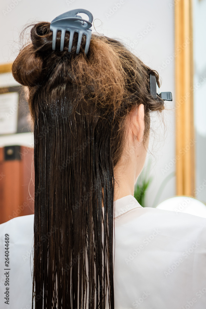 Fototapeta premium Zabieg keratynowy u fryzjera - Keratin treatment at the hairdresser