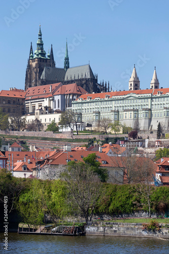 Spring green Prague Lesser Town with gothic Castle above River Vltava in the sunny Day, Czech Republic