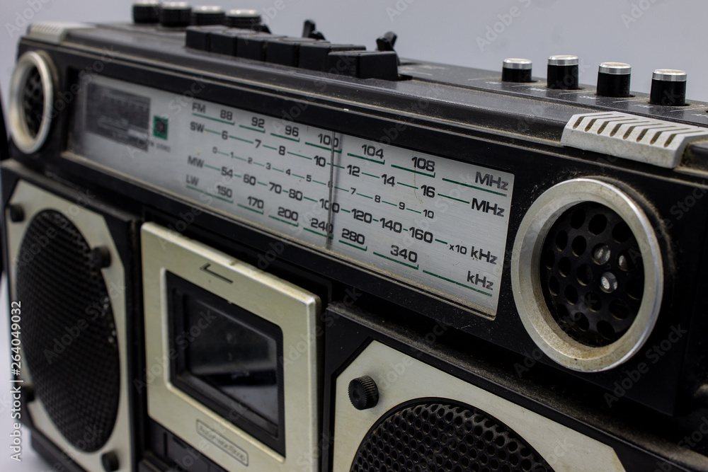 In the 70s and 80s the music was listened to through the cassettes, a  magnetic storage device. The radios were very large, containing two  speakers and a cassette player. Stock Photo