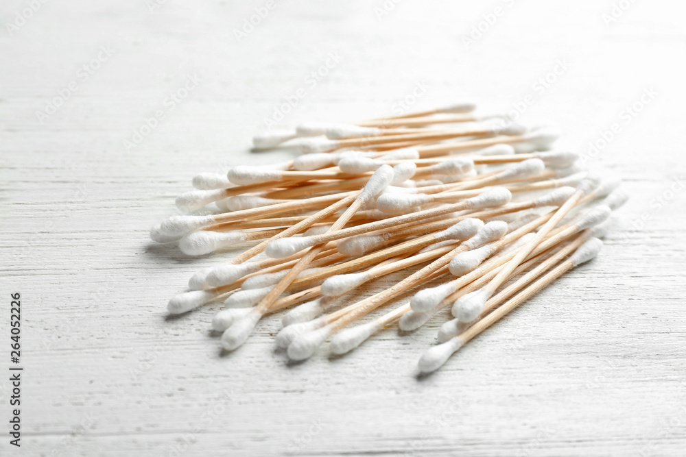 Pile of cotton swabs on white wooden background Pile of cotton swabs on white wooden background