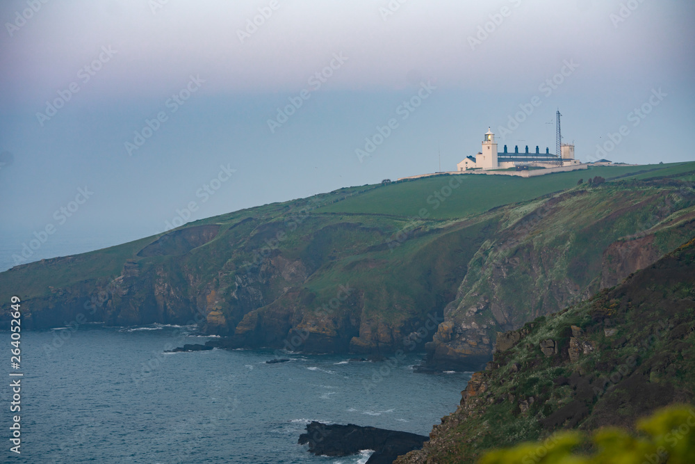 white lighthouse on the coast of england