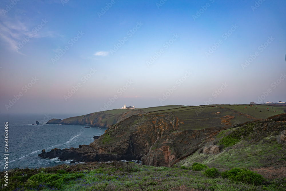 white lighthouse on the coast of england