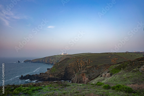 white lighthouse on the coast of england