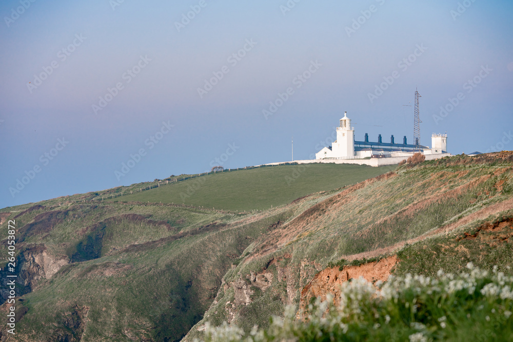 white lighthouse on the coast of england