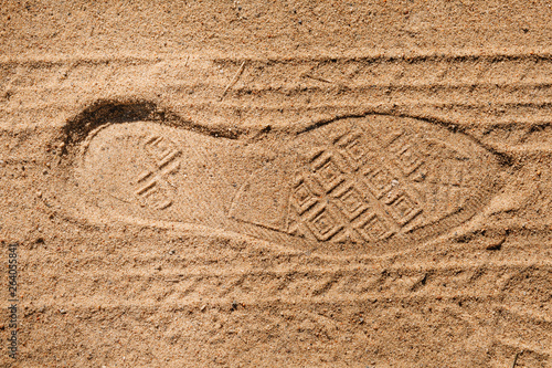 Footprint tread shoes and tires on the sand