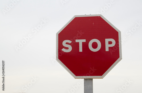 Red stop sign, isolated Traffic regulation warning sign Octagon, octagonal frame white, metal post on white background
