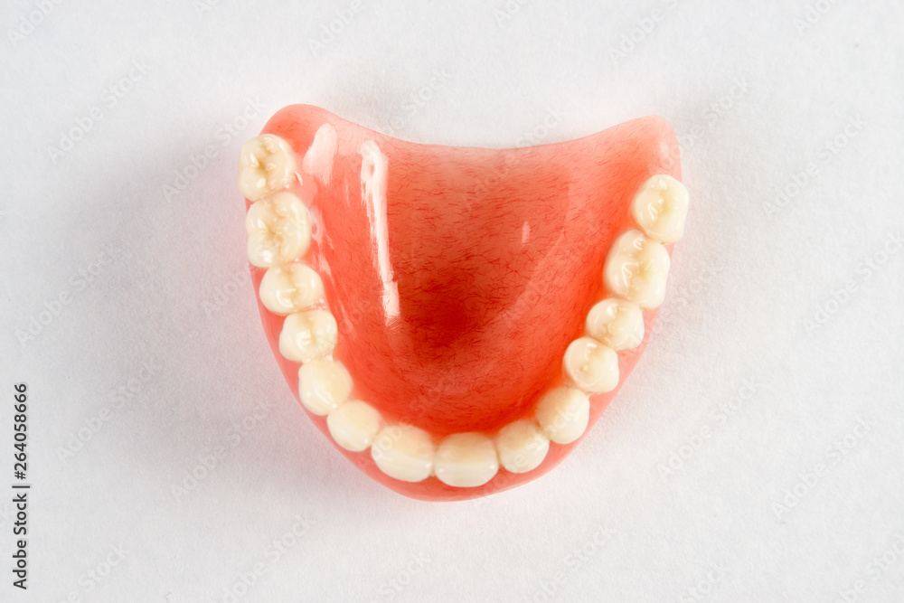 Artificial teeth on a white background with copy space, close-up Artificial teeth on a white background with copy space, close-up