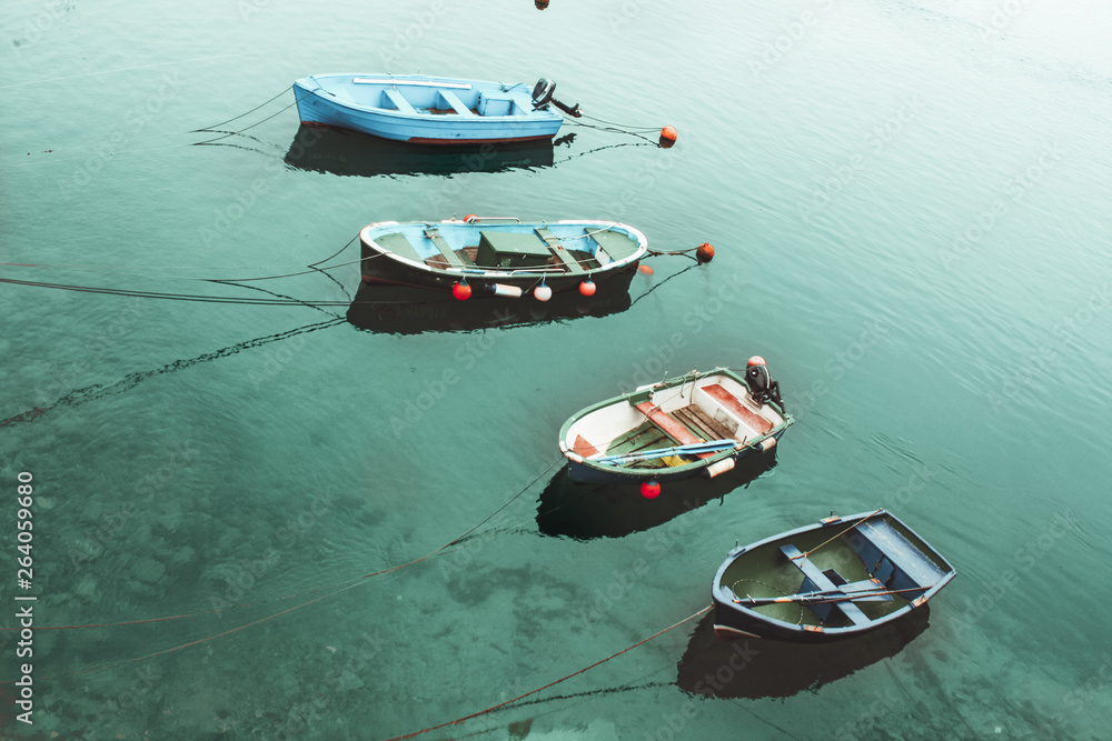 four boats in the turquoise sea