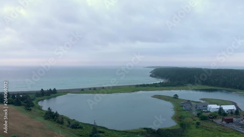 Wallpaper Mural Cinematic drone / aerial footage descending showing a forest and the ocean in Kingsburg, Nova Scotia, Canada during summer season. Torontodigital.ca