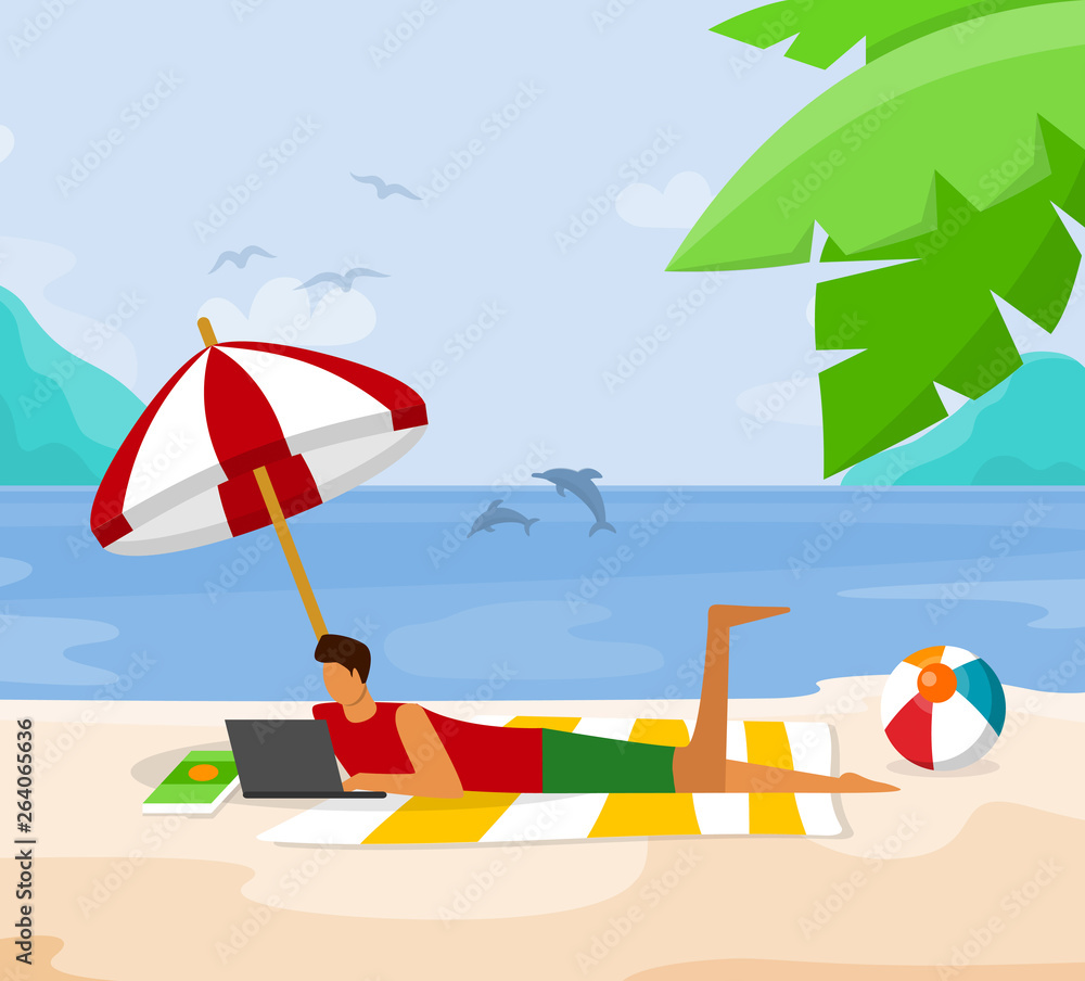 Fototapeta premium Young Man Relaxing on Beach Lying with Laptop