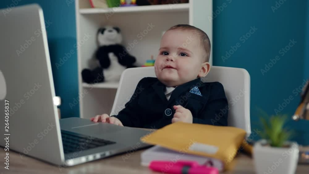 Smiling little boy businessman boss in office use laptop write notebook sitting play creative happy job work child computer education young suit cute career confident close up slow motion Smiling little boy businessman boss in office use laptop write notebook sitting play creative happy job work child computer education young suit cute career confident close up slow motion