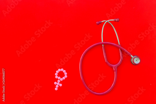 diagnostic and cure of gynaecological disease with stethoscope and female symbol on red background top view mock-up