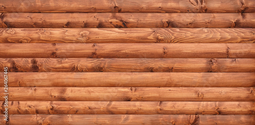 Wooden wall assembled of beams or logs photo