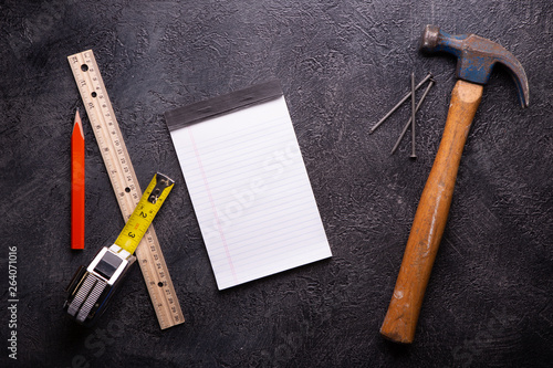 Handyman tools on black textured background