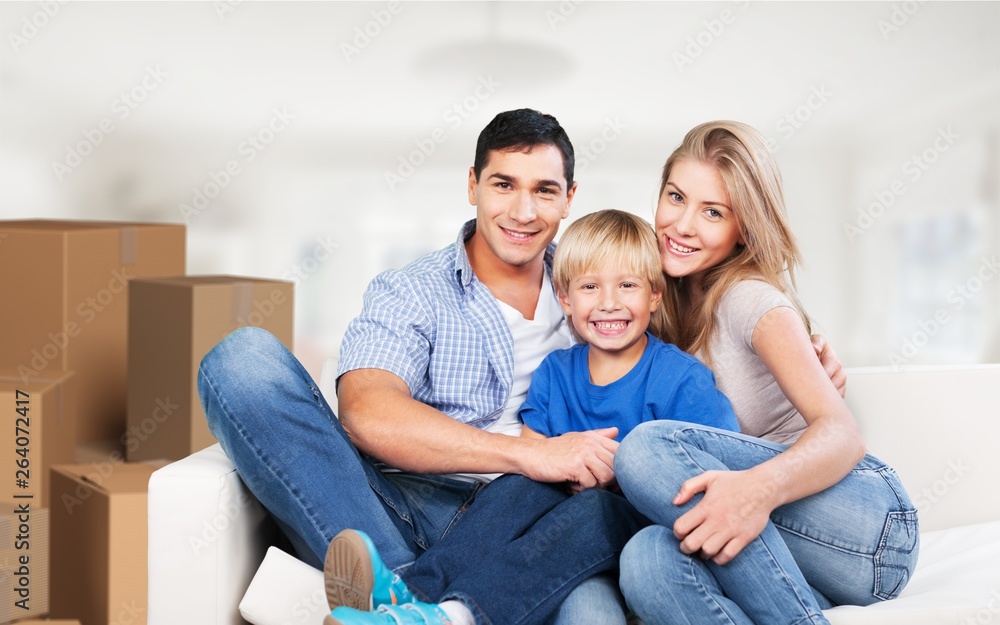 Beautiful smiling family sitting at sofa at home Beautiful smiling family sitting at sofa at home