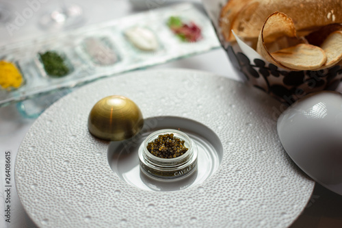 Fresh Caviar for one, served in its box with different condiments