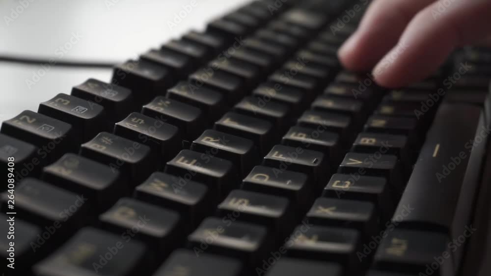 Man close up.fast typing on a black computer mechanical keyboard. Man close up.fast typing on a black computer mechanical keyboard.