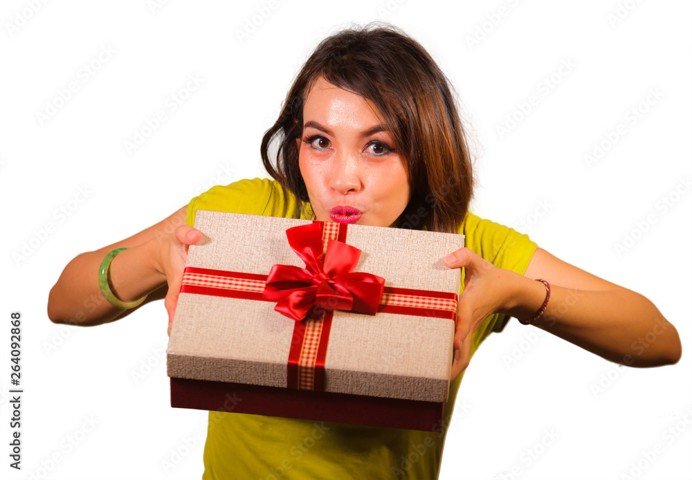 portrait of young happy and beautiful Asian Indonesian woman giving or receiving Christmas present or birthday gift box with red ribbon excited and cheerful smiling portrait of young happy and beautiful Asian Indonesian woman giving or receiving Christmas present or birthday gift box with red ribbon excited and cheerful smiling
