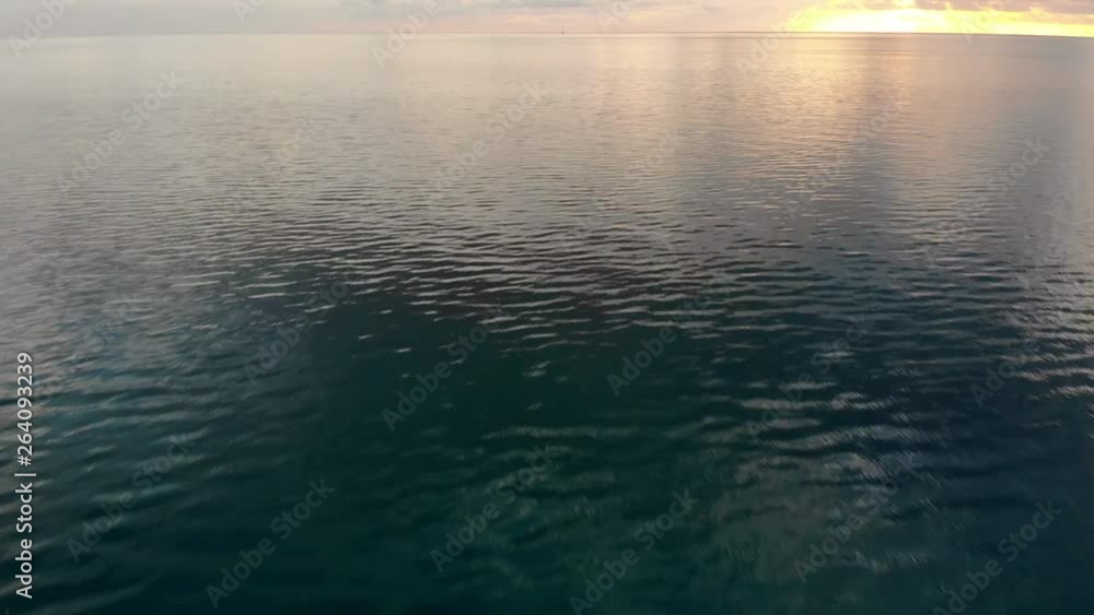 Aerial Forward: Calm, Dark And Light Blue Ocean At Sunset in Bora Bora, French Polynesia Aerial Forward: Calm, Dark And Light Blue Ocean At Sunset in Bora Bora, French Polynesia