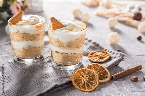 Layered mascarpone dessert with crushed vanilla biscuits and carame photo