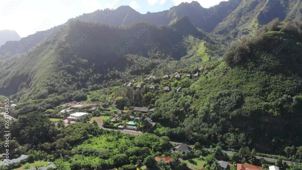 Aerial Forward: Forest Covered Mountains And Valley In Bright Sun in Moorea, French Polynesia Aerial Forward: Forest Covered Mountains And Valley In Bright Sun in Moorea, French Polynesia