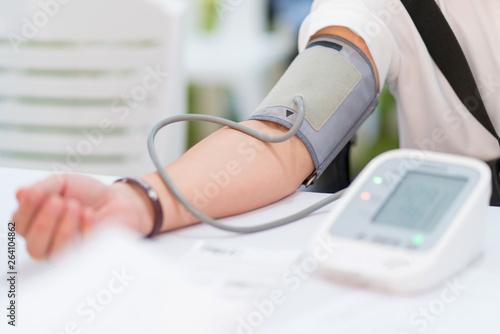 Doctor checking patient arterial blood pressure in hospital. Health care Concept photo