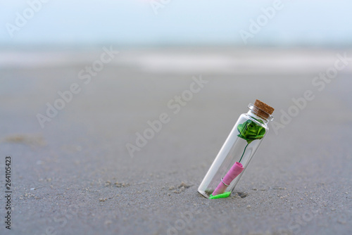 Message or letter in bottle on the tropical beach