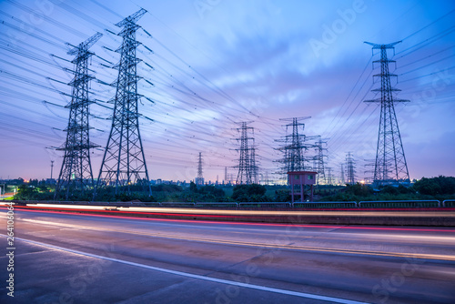 High voltage, high speed road car track in the background of high voltage towers