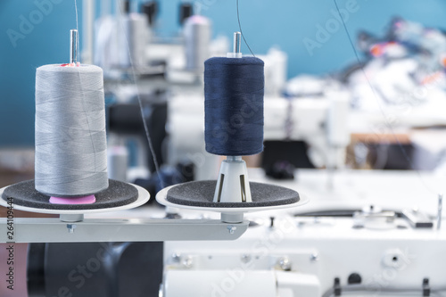 threads. shop tailoring. apparel manufacturing. thread on the sewing machine stand