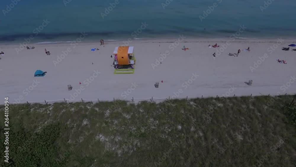 Drone Shooting of the beach. Drone flies sideways capturing Lifeguard tower Drone Shooting of the beach. Drone flies sideways capturing Lifeguard tower
