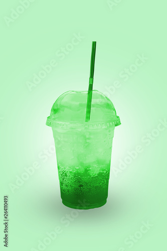 Green juice with ice in a plastic glass with clipping path.