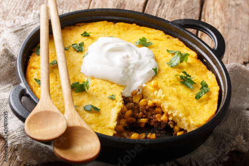 Photography Homemade tamale pie casserole with corn and ground beef and cheese close-up in a frying pan