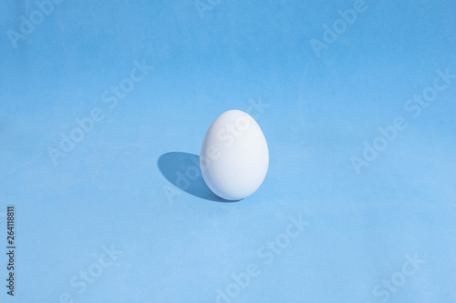  Food background made of white Easter eggs on a blue backdrop