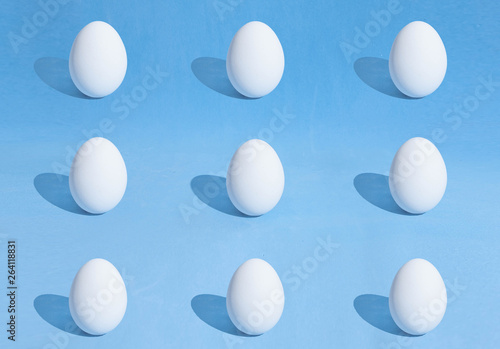  Food background made of white Easter eggs on a blue backdrop