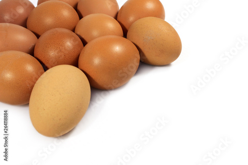 Group of raw Chicken eggs, close-up. side view, white background and place under the text. Lots of brown eggs.
