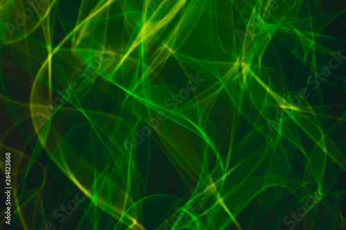 Yellow neon and green neon smoke abstract. Neon lines. Abstract black background. Neon lights texture.