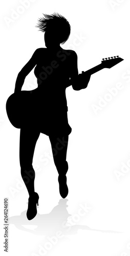 A female guitarist musician in detailed silhouette playing her guitar musical instrument.