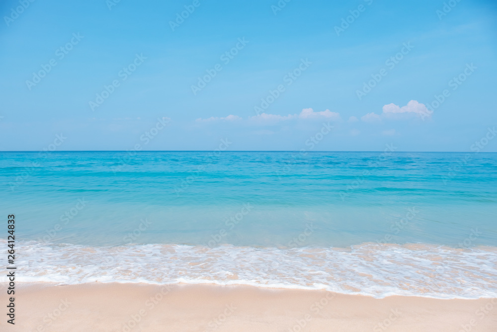 Landscape of tropical beach in summer. Sandy beach with sea waves and blue sky background. Holiday, vacation - Image