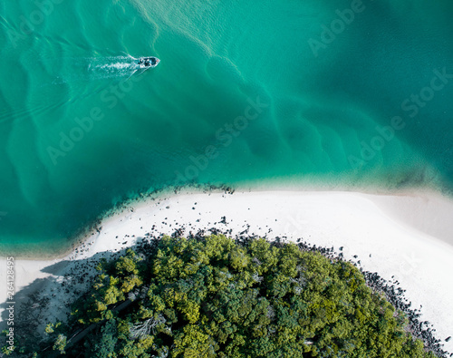 Beach aerial summer with boat and blue tropical water. Beautiful gold coast hot drone shot with boat and sand drift.