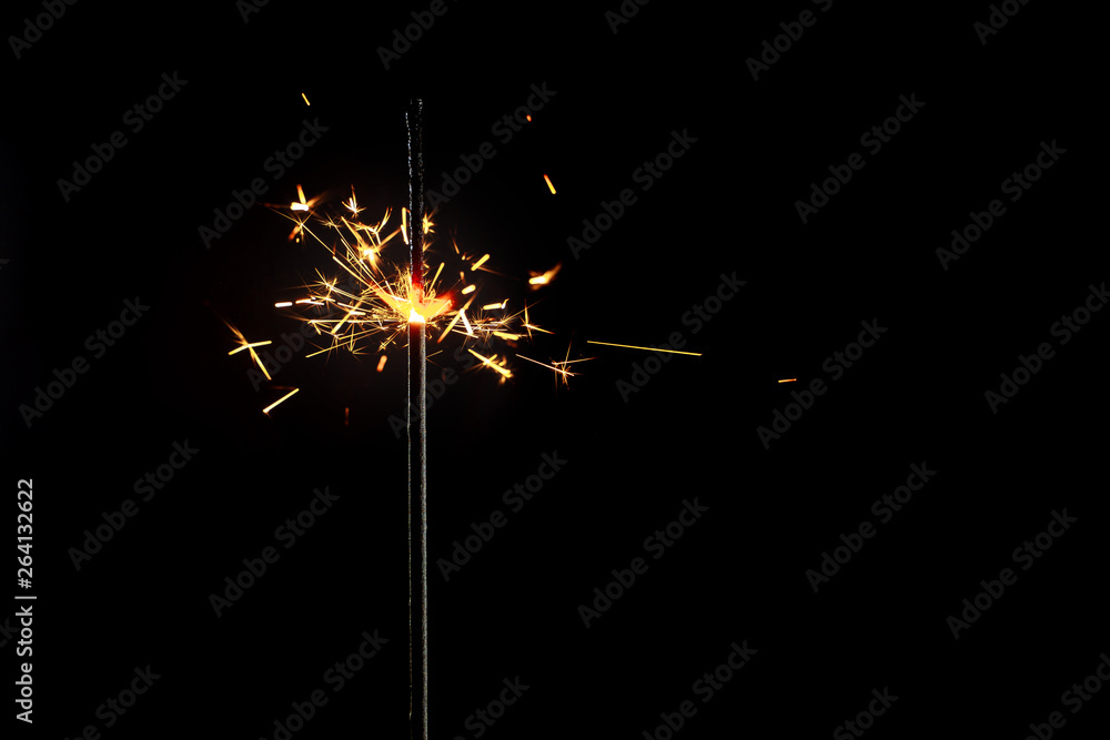 Burning sparkler on black background. Burning sparkler on black background.
