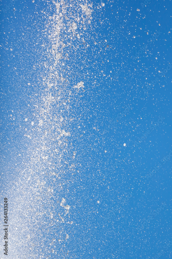 Splashes of water against the blue sky Splashes of water against the blue sky
