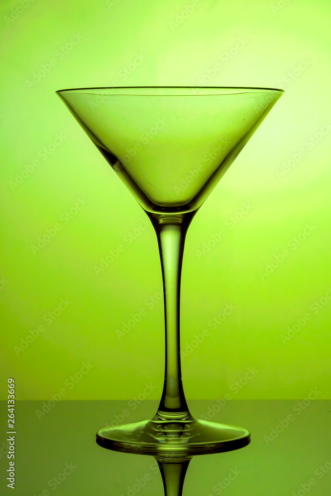 Cocktail glass, the stemmed glass is lit with yellow light Cocktail glass, the stemmed glass is lit with yellow light