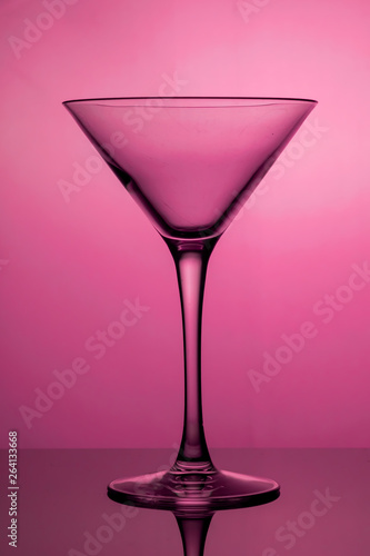 Cocktail glass, the stemmed glass is lit with purple light